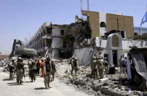 বর্তমান বিশ্ব ও বিশ্বশান্তি রচনা 5 Rescue workers and US Military soldiers search through rubble and debris at the United Nations (UN) Office of Humanitarian Coordinator Building in Baghdad, Iraq, after a truck bombing destroyed much of the building during Operation IRAQI FREEDOM.